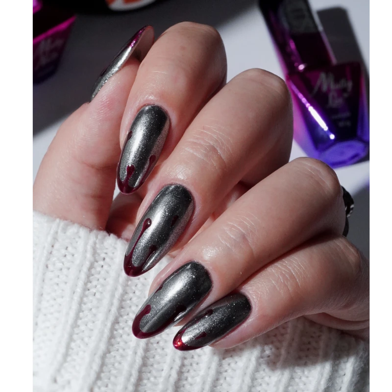 Silver nails with burgundy details resembling dripping drops