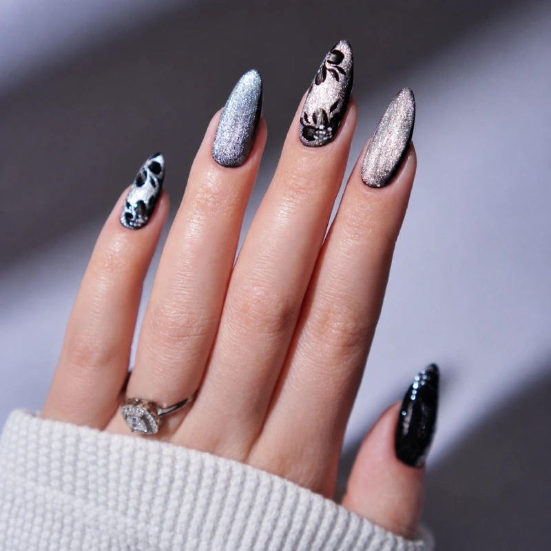 Silver nails with black floral details and a shimmering finish