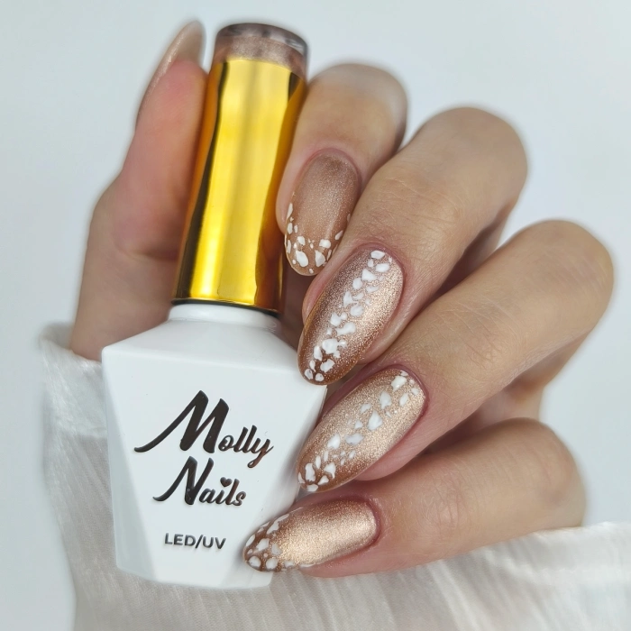 Gold animal-print nails with a white snakeskin-inspired design and Molly Nails gel polish